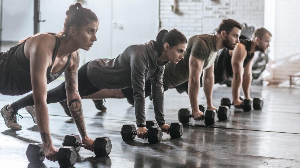 Sportspeople Doing Pushups at Gym