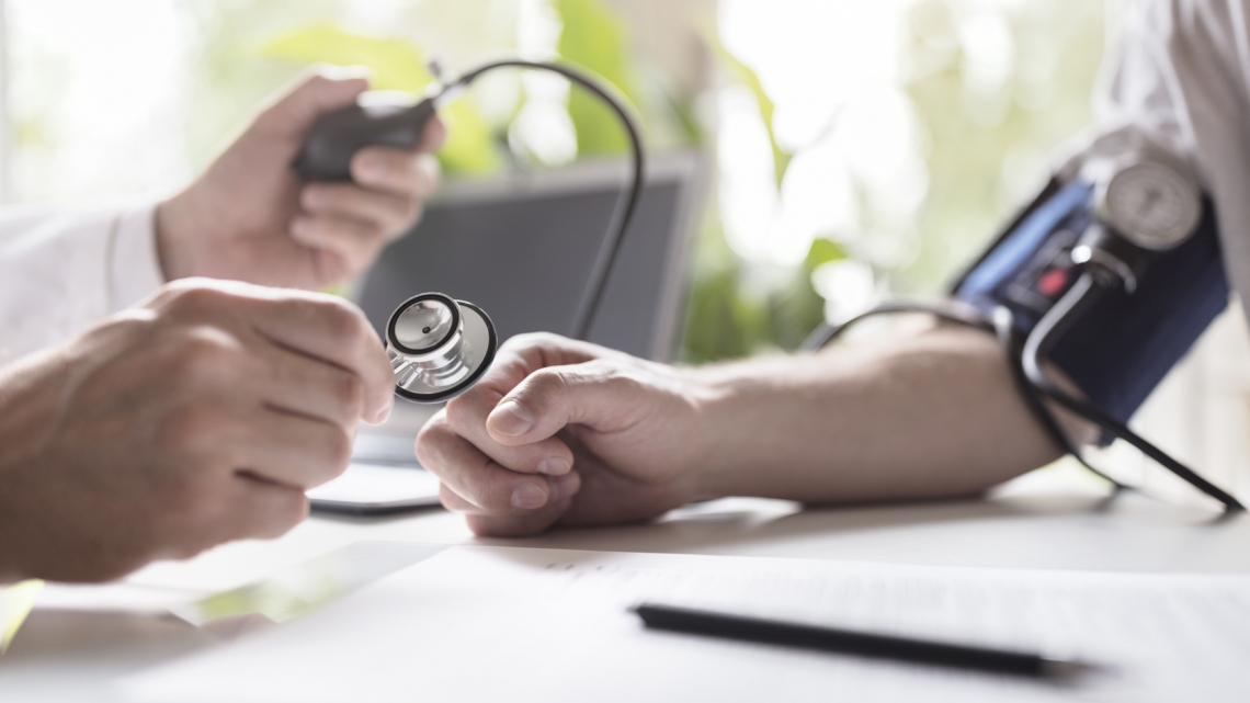 Doctor measuring blood pressure of patient
